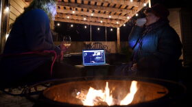 Neighbors sit around a fire-pit to watch Eddie Vedder perform during the "One World: Together at Home" concert in a backyard in Arlington, Virginia.
