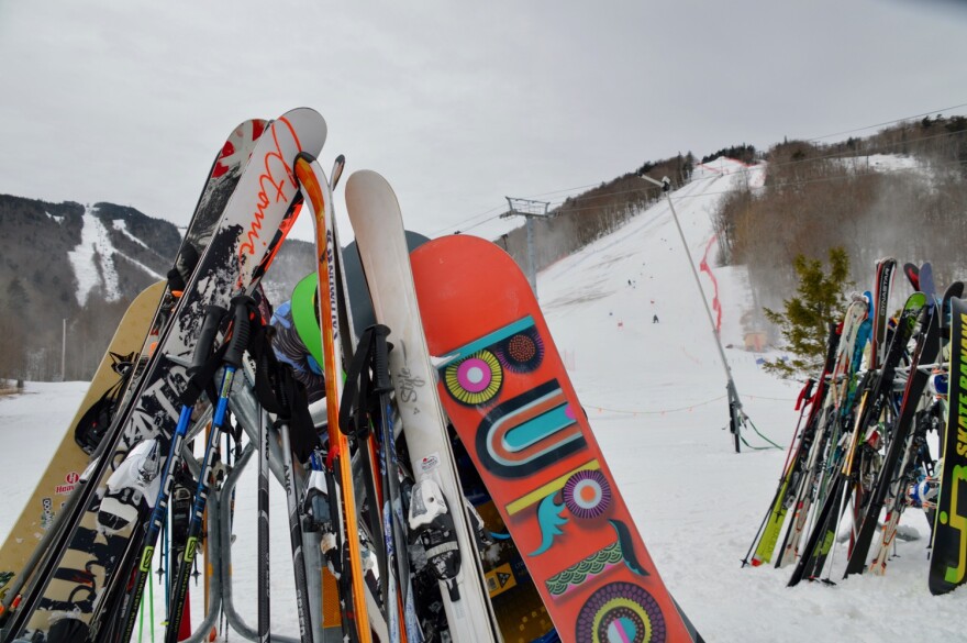 Lots of skis propped up at the base of a mountain at Killington.