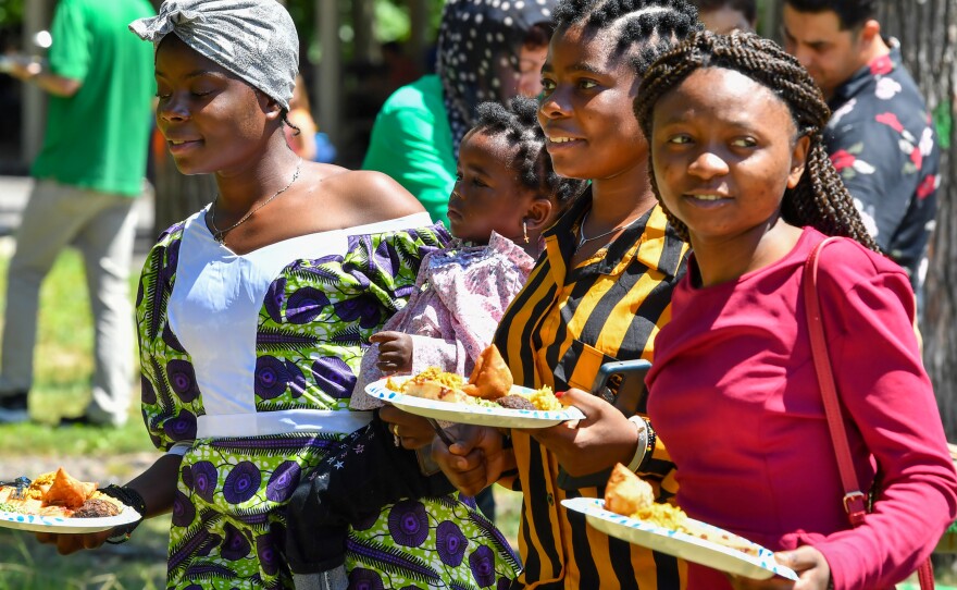 Women try various ethnic foods at World Refugee Day.