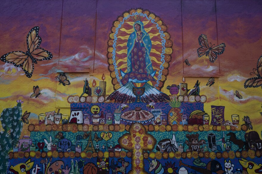 A mural painted by artist Lizbeth Ortiz and Leticia Santos depicting an altar for the children and teachers who were killed during the mass shooting at Robb Elementary School.