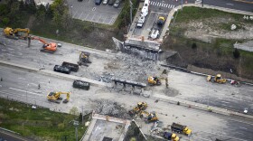 This aerial view shows demolition crews working to finish removing the Fairfield Avenue bridge over Interstate 95, Saturday, May 4, 2024 in Norwalk, Conn. Crews are expected to finish removing the bridge by Sunday morning, and road repairs will be made. The tanker truck burst into flames under the overpass after colliding with two other vehicles Thursday. The cause remains under investigation.