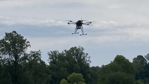 A drone equipped by NASA rises over UVA's Morven Farm.