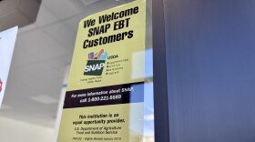Signage about SNAP benefits, known in Vermont as 3SquaresVT, remains on the door of a former grocery store in Essex Junction.