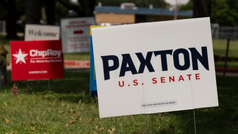 Candidate signs, including one for Republican Senate primary candidate and current Texas Attorney General Ken Paxton, line the entrance to the Royal Lane Baptist Church polling location as voters cast ballots during local and primary runoff elections, including the closely watched Texas Republican Senate runoff, Tuesday, May 26, 2026, in Dallas.