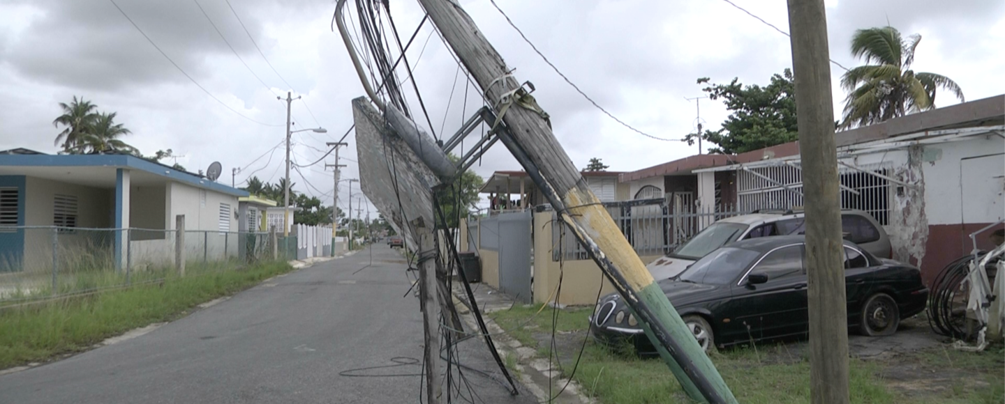 Victor Cartagena has two cars parked outside his house in Toa Baja.