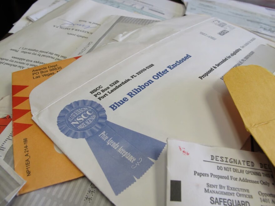 This Monday, June 11, 2012, file photo shows piles of official-looking sweepstakes and other mailings spread on a table at the North Carolina Attorney General's office in Raleigh, N.C.