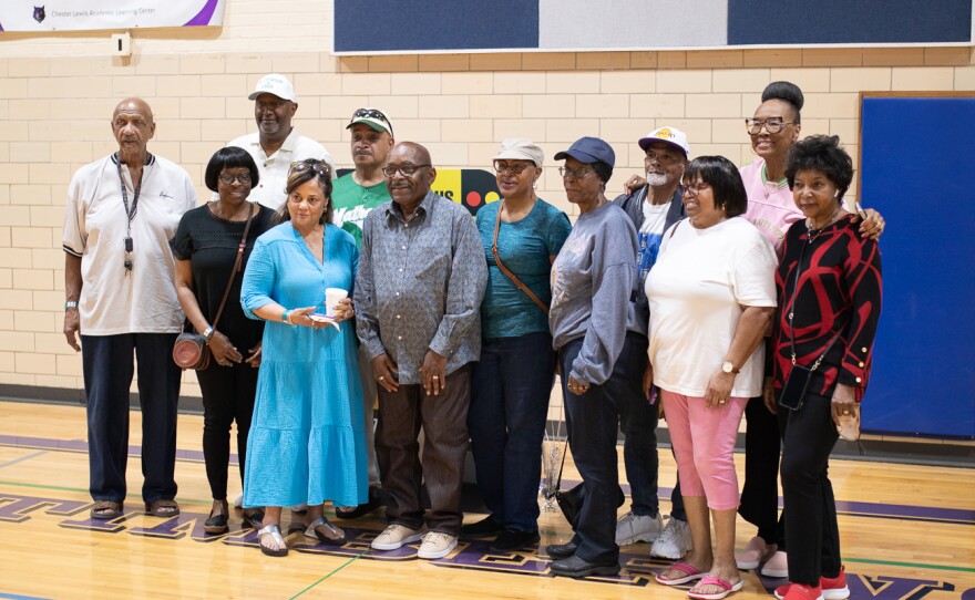 Graduates from Mathewson Junior High pose for a group photo on March 26. The building, most recently home to Chester I. Lewis Alternative High School, is set to be demolished this summer.