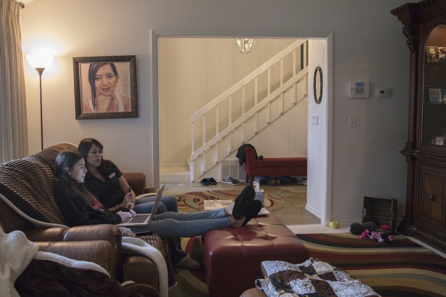 Evelyn and April sit below a portrait of Carmen. The painting, acrylic on canvas, is by Parkland artist Nava Lundy, who created portraits of all 17 Parkland victims and gave them to the families. "I just felt this urgency," Lundy says. "I felt like I had to do something to help the families in whatever way I could."