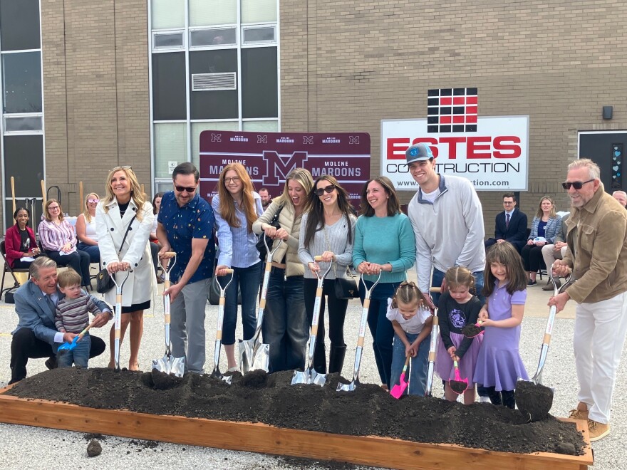 Chris Ontiveros (far left, kneeling) helps several students in one of many ceremonial groundbreakings Wednesday for the Robert Ontiveros Elementary School, Moline, on March 25, 2026.
