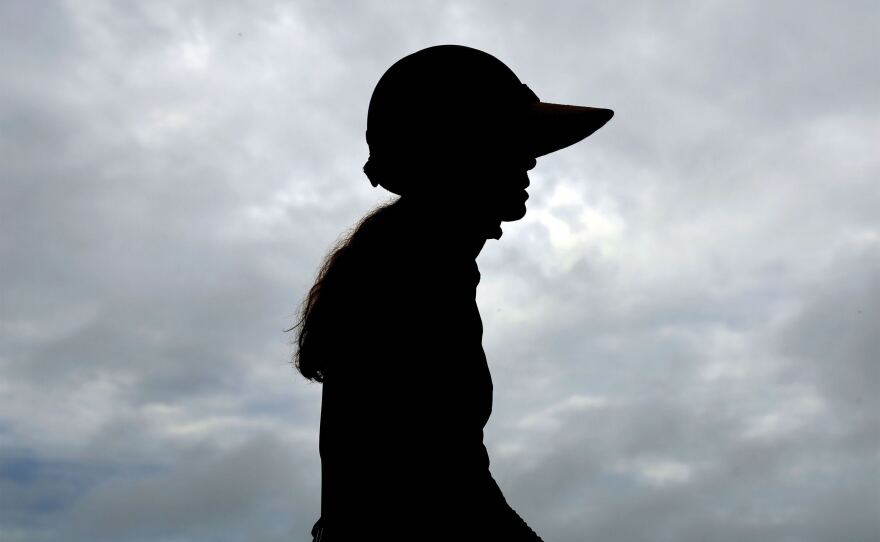 Ashley Johnson, 48, is silhouetted against an overcast sky while atop her horse on Wednesday, Sept. 27, 2023. Johnson said she has felt a connection to horses since she was young. “I learned to ride before I even remember learning to ride,” Johnson said. “It’s like floating in the ocean, it’s just a natural movement to me.”