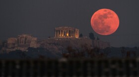 A super blue blood moon rises behind the 2,500-year-old Parthenon temple on the Acropolis of Athens, Greece on Jan. 31, 2018. (Petros Giannakouris/AP)