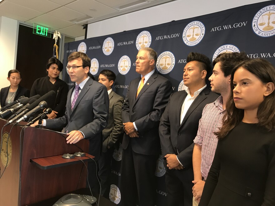 Attorney General Bob Ferguson and Gov. Jay Inslee of Washington state, surrounded by DACA recipients, denounce the Trump Administration's plan to end the federal protection program for young immigrants. 