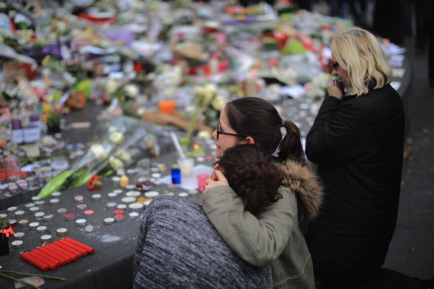 People weep as they gather Monday at the Place de la Republique to observe a minute of silence in memory of the victims of the Paris terror attacks.