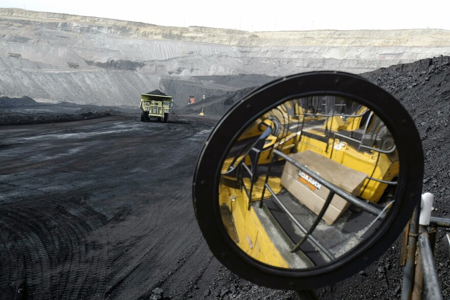 A coal-hauling truck with 240 tons of coal drives to the surface at the Buckskin Coal Mine in Gillette, Wyo., in 2004.