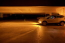 A vehicle’s headlights illuminate a dark parking garage on Michigan State University’s East Lansing campus during the widespread power outage Saturday night, Sept. 19, 2026.