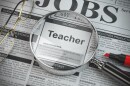 Teacher vacancy in the ad of job search newspaper with loupe.