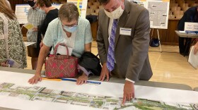 Mark Frechette, a project manager with the state transportation department, points out an item on a map to meeting attendee, Sept. 23, 2021.