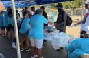 Volunteers serve lunch outside at the Roof Above Day Center. 