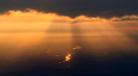 Light reflects off the water as the sun sets through wildfire smoke over Edmonton, Alberta, Friday, July 17, 2026. (Andy Bao/AP)
