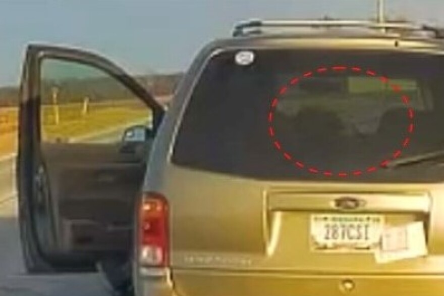 A photo from the special prosecutor’s statement shows Huttle on dash camera footage reaching into his vehicle at the traffic stop.