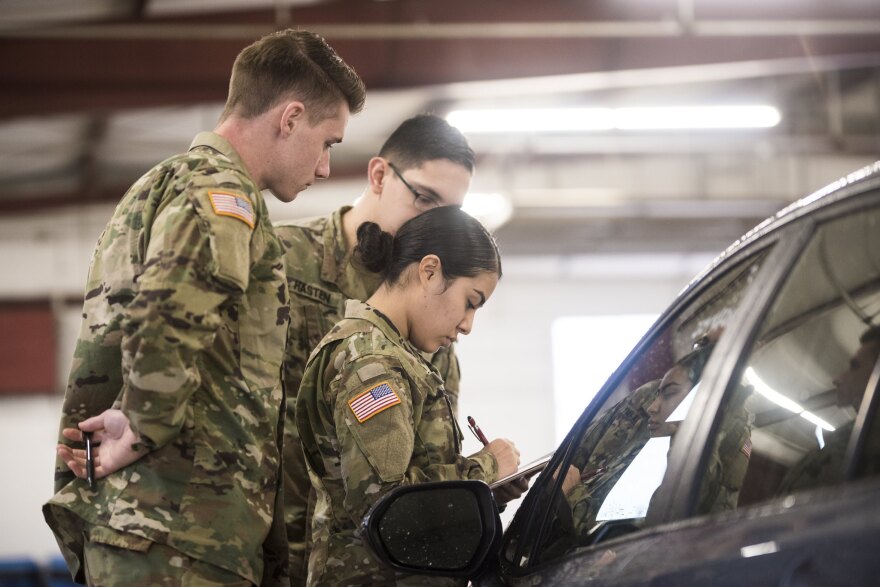 Guard members at a car