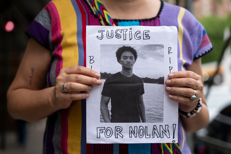 A person holds a picture of Nolan Xavier Wells during a news conference at National Action Network headquarters, Friday, July 10, 2026, in New York. (AP Photo/Yuki Iwamura)