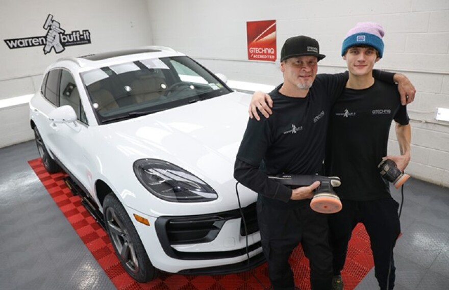 Warren Mapes, owner of Warren Buff-It, and his son Connor Mapes take a pause from detailing a 2023 Porsche Macan.