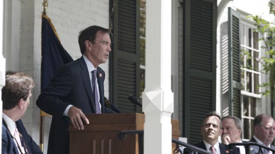Craig Bouchard speaks at a Braidy Industries launch event as KY Gov. Matt Bevin (right) looks on.