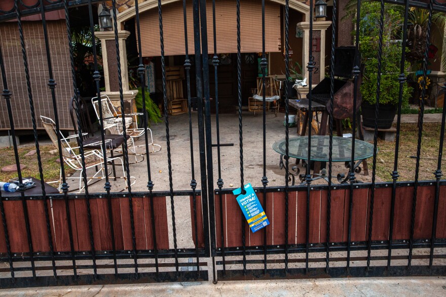 A door hanger from LUPE promoting voting is left on the front gate of a home in San Juan, Texas.