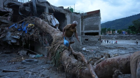 A resident salvages belongings from his damaged home after flash flooding in the Devighat area of Nuwakot district in Nepal, Monday, Aug. 31, 2026.