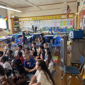 Students sit in front of an oscillating fan on the first day of school on Sept.