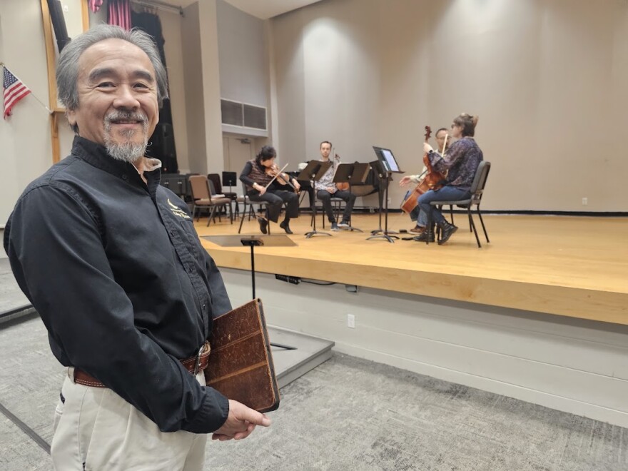 Dr. Kiminobu Sugaya watches his wife, Ayako Yonetani, and the Pegasus String Quartet practice ahead of a concert at the UCF Rehearsal Hall.