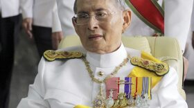 In this Dec. 5, 2011, file photo, Thailand's King Bhumibol Adulyadej is pushed on a wheelchair while leaving Siriraj hospital for the Grand Palace for a ceremony celebrating his birthday in Bangkok. (Apichart Weerawong/AP)