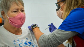Karla Hunt, a registered nurse with the Platte County Health Dept., vaccinates Phyllis McCaslin, 73, during a mass vaccination clinic in Riverside on Tuesday morning.