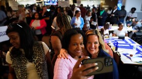 Michigan Secretary of State Jocelyn Benson, right center, the Democratic gubernatorial nominee, poses for a photo with Rose Dady, at a campaign event at the Trade Union Leadership Council in Detroit, Tuesday, Aug. 18, 2026. (AP Photo/Paul Sancya)