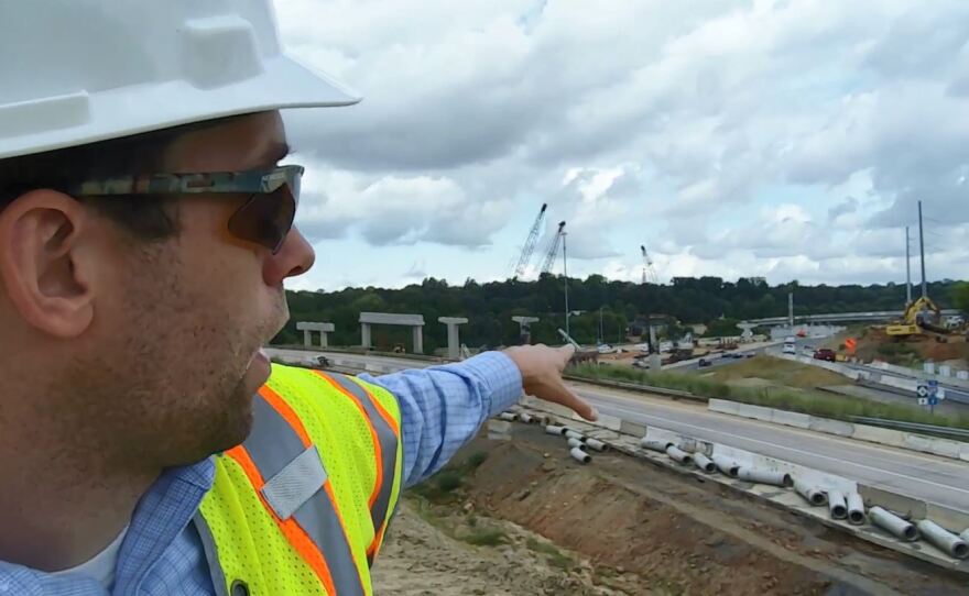 David Hannon of I-77 Mobility Partners points to ramp construction at the I-277 and I-77 interchange in Charlotte during a tour this week. 