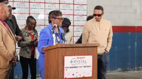 State Assembly Majority Leader Crystal Peoples-Stokes, behind lectern, announces she won't seek re-election in the fall.