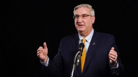 Indiana Republican Gov. Eric Holcomb participates in the Indiana Gubernatorial debate with Democrat Woody Myers and Libertarian Donald Rainwater, Tuesday, Oct. 27, 2020, in Indianapolis. The candidates were in separate studios to allow for social distancing guidelines.