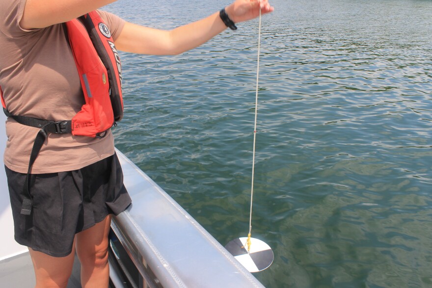 Testing for water clarity in Candlewood Lake.