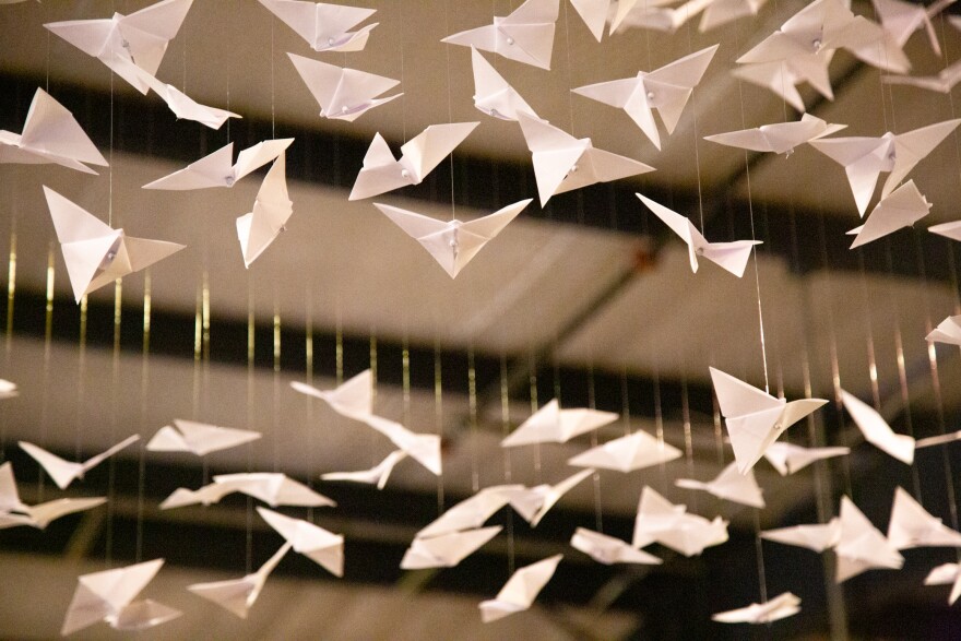 Origami butterflies hang from strings