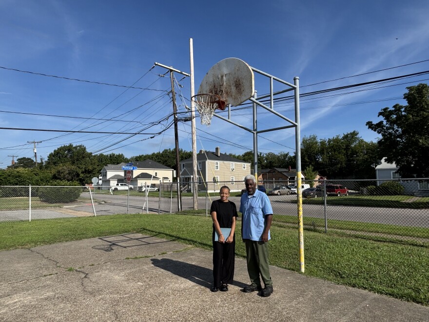 Zuri Askew and her father, Mark Askew Sr., stand on the old basketball court at the former Coronado School in Norfolk on Monday, July 28, 2025.