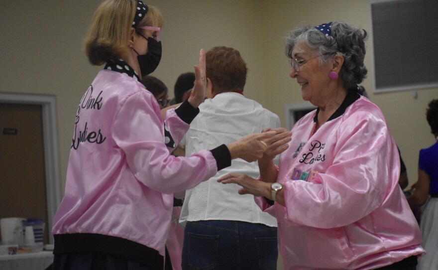 Becky Tompson (left) and her partner dance to the music and calls at the High Springs Dance Club. (Kennedy Lerner/WUFT News)