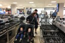 Carla and Jeremy Lang push their twin 18-month-old sons in a stroller while looking at ovens and stoves at a Sears northwest of Chicago.