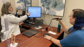 Speech pathologist Karen Crow is working with client Lindsey Ricketts with vocal exercises measuring pitch