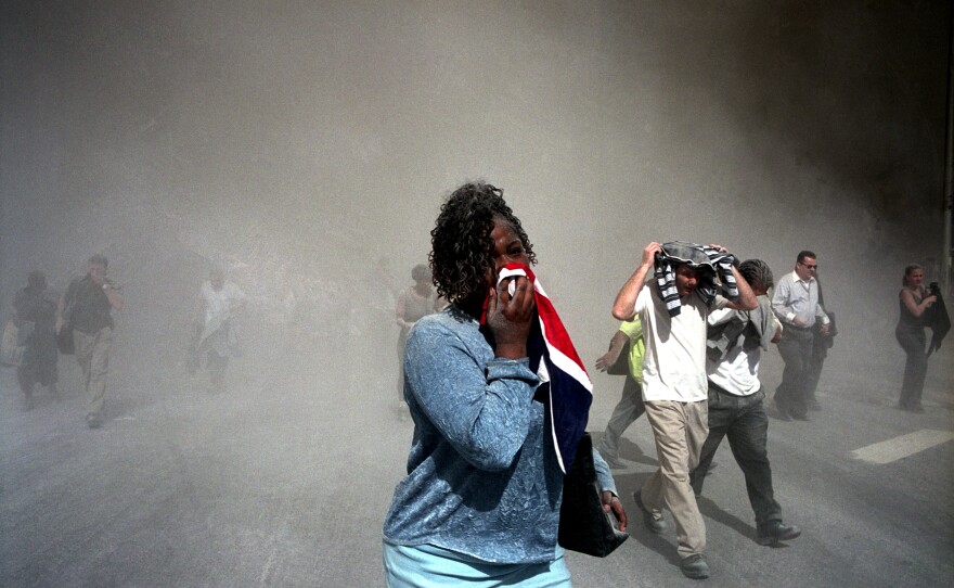 People use masks made out of clothing to protect themselves from dust that is thick in the air after the collapse of the World Trade Center towers.