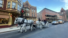 Tourists ride in a horse and carriage along Broadway in Jim Thorpe.