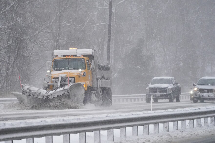 Vehicles follow a snowplow on Highway 50 during a snowstorm, Saturday, Jan. 29, 2022, in Mardela Springs, Maryland.  The Maryland State Highway Administration began pre-treating major highways on Friday with de-icing chemicals to keep the roadways clear during Sunday's expected snowstorm. 