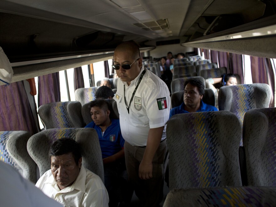 An immigration official checks a bus for Central American migrants at a roadblock north of Arriaga, Chiapas state, Mexico. In recent years the country has apprehended and deported more Central American migrants than the U.S. has.