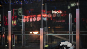 A person sleeps on an overpass along the Las Vegas Strip, Wednesday, Nov. 11, 2020.