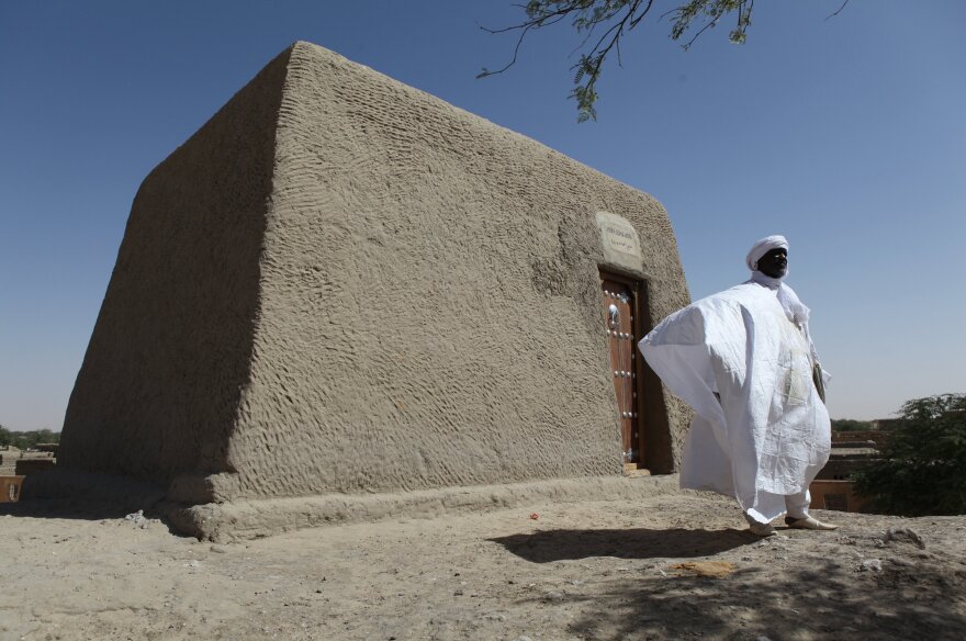 Sane Chirfi, representing the family that looks after the mausoleum of Alpha Moya, poses in front of the mausoleum on Feb. 4 in Timbuktu. Historic mausoleums, destroyed during an Islamist takeover of northern Mali in 2012, were rebuilt thanks to the U.N. cultural agency UNESCO.